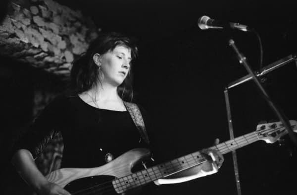 A teenage Rachael King playing bass with The Cakekitchen.
