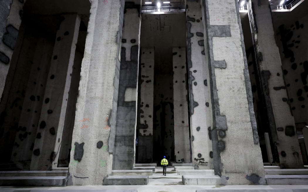 A man walks in the Austerlitz wastewater and rainwater storage basin, which is intended to make the Seine River swimmable during the Olympic Games, in Paris, during its inauguration on 2 May, 2024.