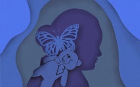 Cut paper silhouette of girl, teddy bear and butterfly