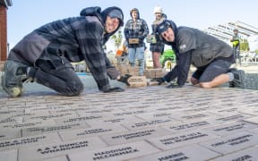 Ryan Godden, left, Seth Maze, Aimee Wood and Jason Maze from Maze landscapes Ltd flew from Taupo to help lay the bricks for the Southland Charity Hospital pathways.