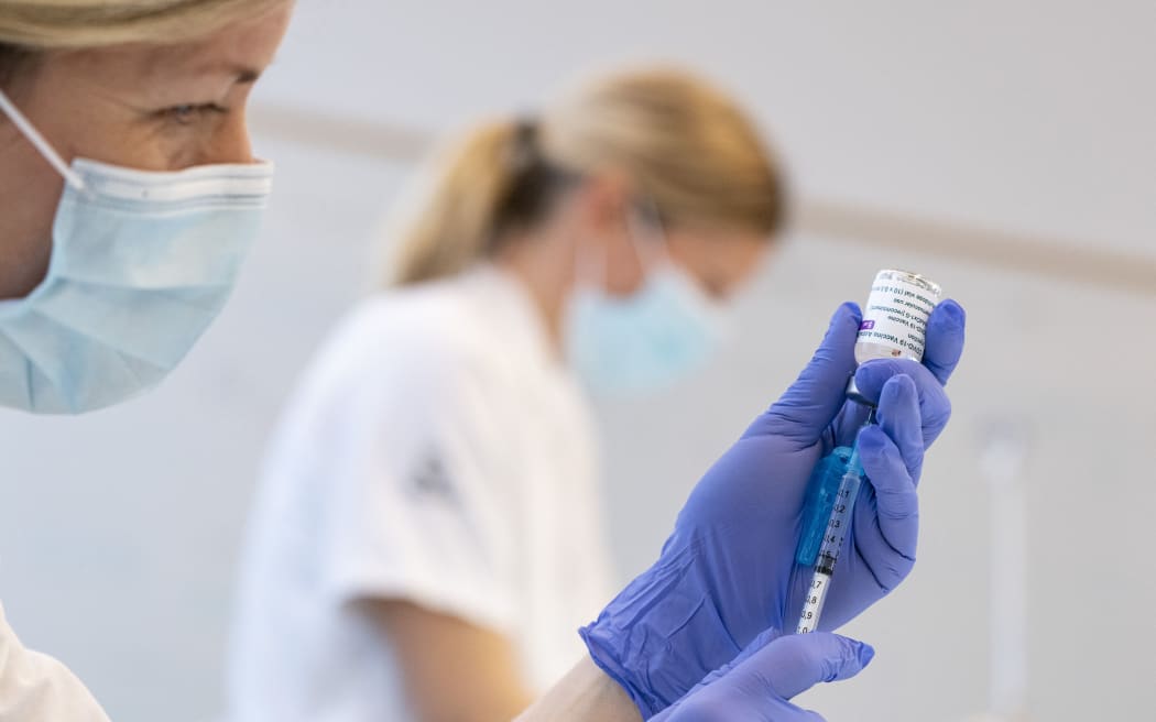A nurse wearing gloves holding a syringe which is being filled with Covid-19 vaccine made by AstraZeneca in Malmo, Sweden
Photo: Johan Nilsson / TT / Code 50090