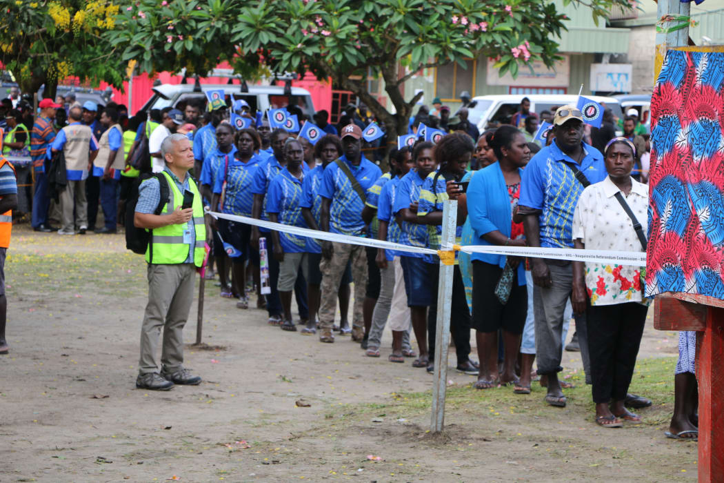 People queue at a referendum polling booth in Buka as voting gets underway in Bougainville for the autonomous PNG region's referendum on possible independence.