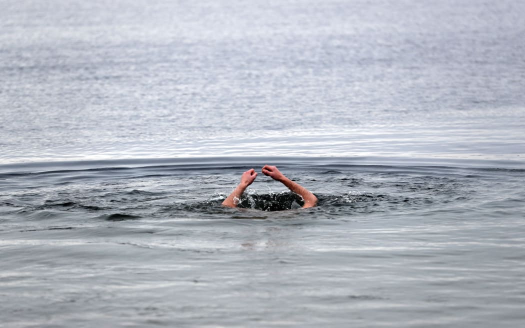 Church members dive into the three degrees Celsius cold water of Schwerin lake during the fifth Russian-Orthodox water sanctification in Schwerin, Germany, 19 January 2017. According to the Gregorian calendar, 19 January is the day of the baptism of Jesus. Photo: Jens Büttner/dpa-Zentralbild/dpa (Photo by JENS BUTTNER / DPA / dpa Picture-Alliance via AFP)