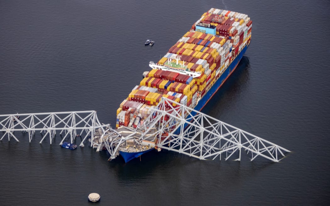 BALTIMORE, MARYLAND - MARCH 26: In an aerial view, cargo ship Dali is seen after running into and collapsing the Francis Scott Key Bridge on March 26, 2024 in Baltimore, Maryland. Rescuers are searching for at least seven people, authorities say, while two others have been pulled from the Patapsco River.   Tasos Katopodis/Getty Images/AFP (Photo by TASOS KATOPODIS / GETTY IMAGES NORTH AMERICA / Getty Images via AFP)