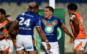 Michael Sio of the Warriors celebrates a try from Solomon Vasuvulagi of the Warriors.