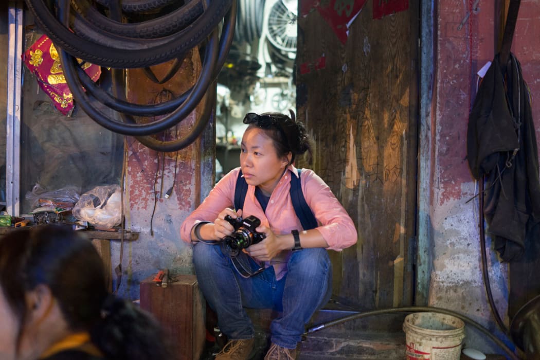 Documentary photographer Sim Chi Yin on assignment.