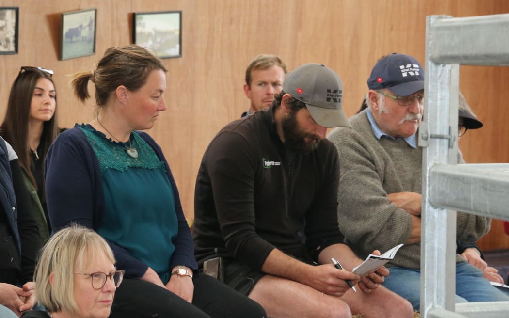 Farmers and agents wait for the auction to start