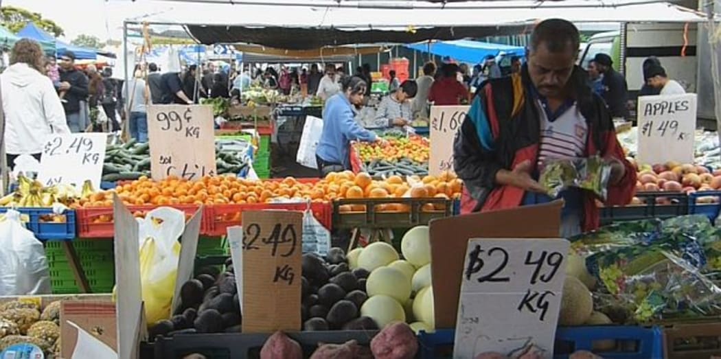 Shopper looking over vegetables at Otara Market in South Auckland