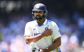 Rohit Sharma exits the field after being dismissed on day five of the fourth cricket test between Australian and India at the Melbourne Cricket Ground.