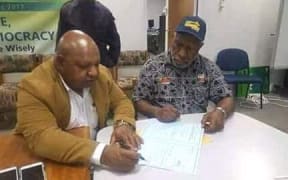 William Powi signs the election writ after winning back the Southern Highlands regional seat in Papua new Guinea.