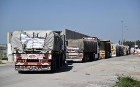 Trucks carrying humanitarian aid arrive from Egypt to the Israeli side of the Kerem Shalom border crossing with the southern Gaza Strip on December 22, 2023, amid the ongoing conflict between Israel and the Palestinian militant group Hamas.