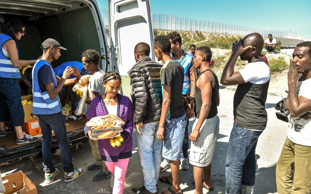 Migrants queue for food at a camp in Calais, northern France.