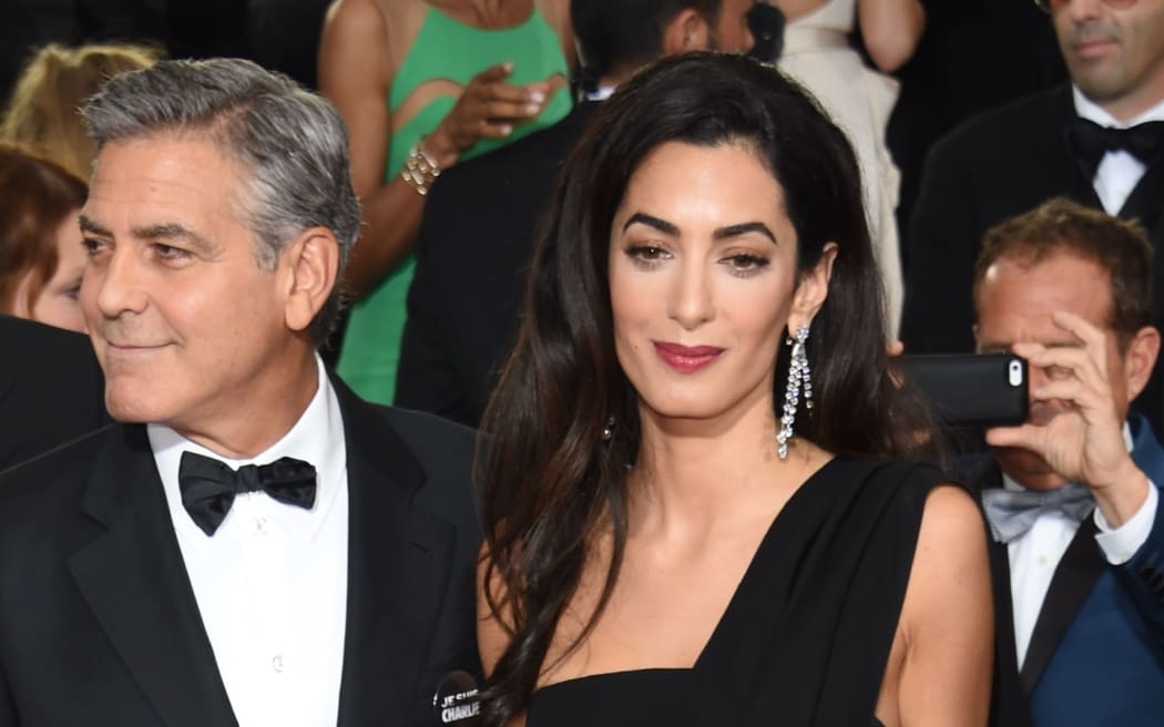Actor George Clooney (L) and Amal Clooney.