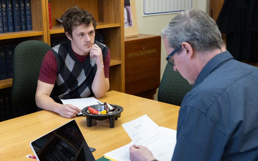 Green Party Policy Advisor, James Coad checks a question with Principal Clerk David Bagnall.