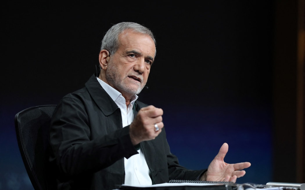 This handout photo made available by the state television Islamic Republic of Iran Broadcasting News (IRIBNEWS) on July 2, 2024 shows reformist candidate Massoud Pezeshkian taking part in a televised election debate at the Iran State television studio in Tehran. The first round of Iran's presidential election revealed shrinking support for both reformists and conservatives even though some voters are pushing for change by backing the sole reformist candidate, analysts say. Masoud Pezeshkian, the reformist contender, and ultraconservative Saeed Jalili led the polls held on Friday to replace the late ultraconservative president Ebrahim Raisi, who died in a helicopter crash last month. The sole reformist in Iran's presidential election, Masoud Pezeshkian, will face the ultraconservative Saeed Jalili in a runoff, authorities said on Saturday, following a vote marred by historically low turnout. The sole reformist in Iran's presidential election, Masoud Pezeshkian, will face the ultraconservative Saeed Jalili...