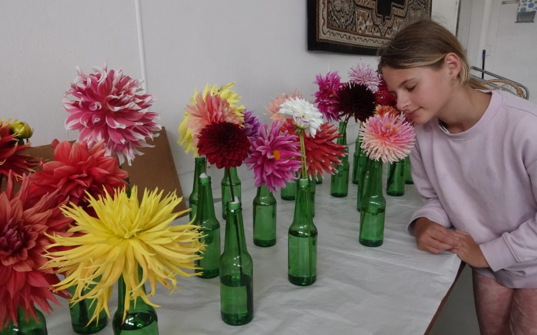 Twelve-year-old Christie Price, from Waimate North, sniffs a bloom in the flower competition.