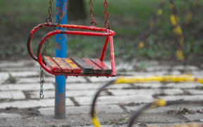 Rusty swing in playground