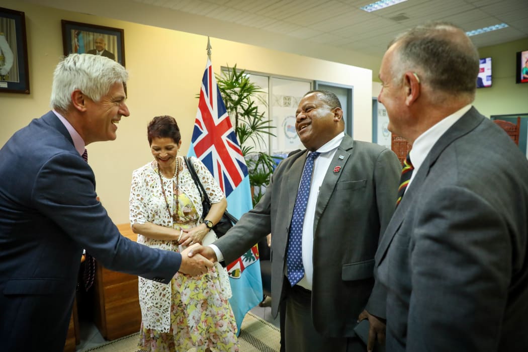 Fiji Minister of Foreign Affairs Inia Seruiratu shakes hands with National MP Tim MacIndoe