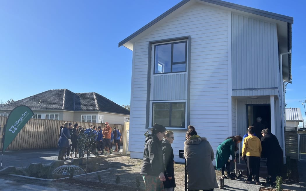 Family and friends take their shoes off when entering the new house after a blessing from kaikarakia Morehu Pewhairangi.