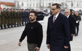 Ukrainian President Volodymyr Zelensky (L) and Polish Prime Minister Mateusz Morawiecki arrive for a wreath-laying ceremony at The Tomb of the Unknown Soldier in Warsaw, Poland, on April 5, 2023. (Photo by Wojtek Radwanski / AFP)