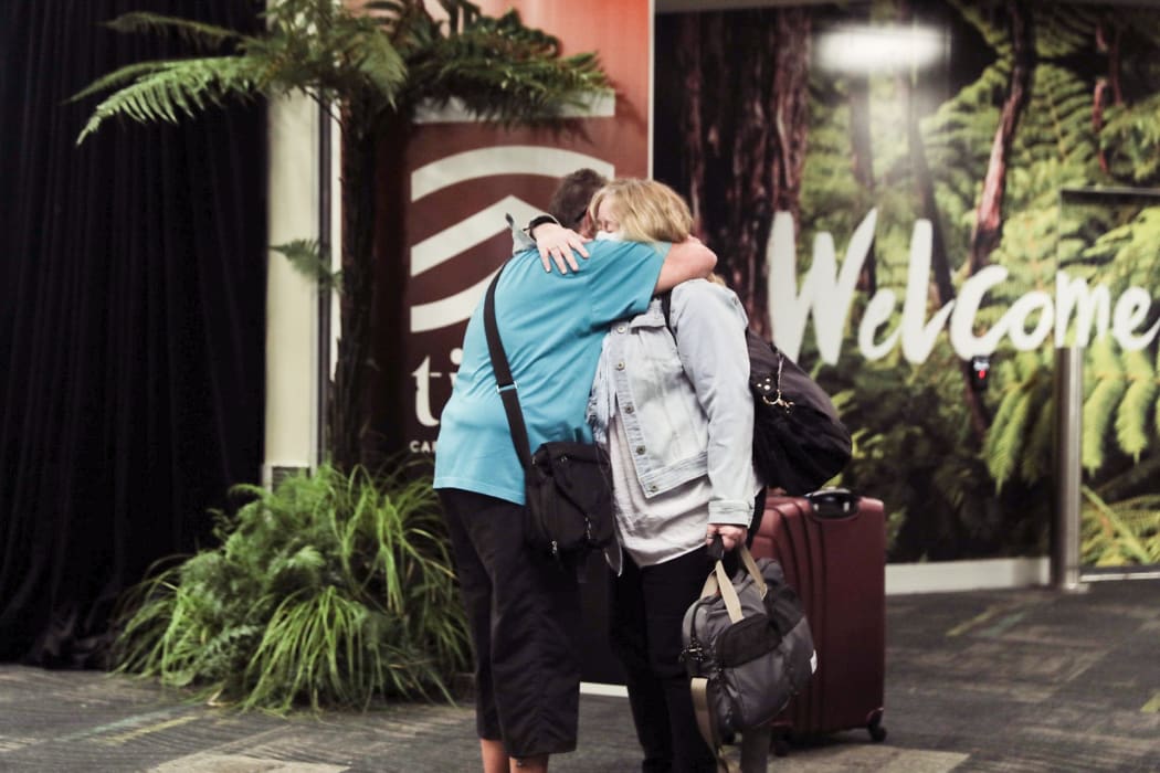 A passenger is reunited with loved ones after the first quarantine-free Wellington flight from Australia disembarks.