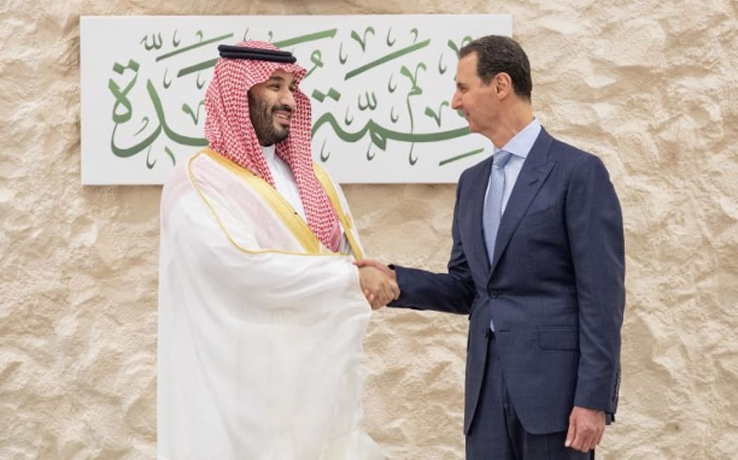 Saudi Crown Prince Mohammed bin Salman (L) shakes hands with Syria's President Bashar al-Assad on the sidelines of the Arab Summit meeting in Jeddah.