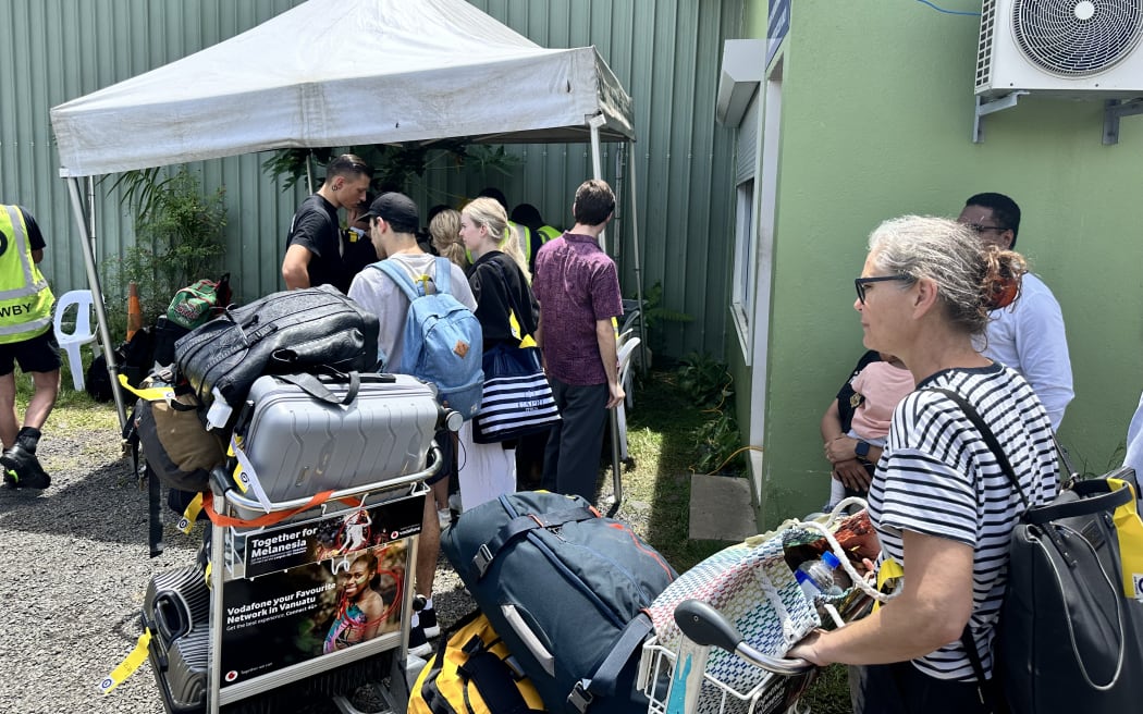 People queue at Port Vila's airport for the last repatriation flight planned to New Zealand, as earthquake response efforts continue in Vanuatu, on 21 December, 2024.