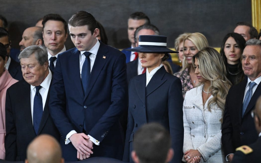 Melania Trump stands alongside her son Barron Trump during the inauguration ceremony before Donald Trump is sworn in as the 47th US President in the US Capitol Rotunda in Washington, DC, on January 20, 2025