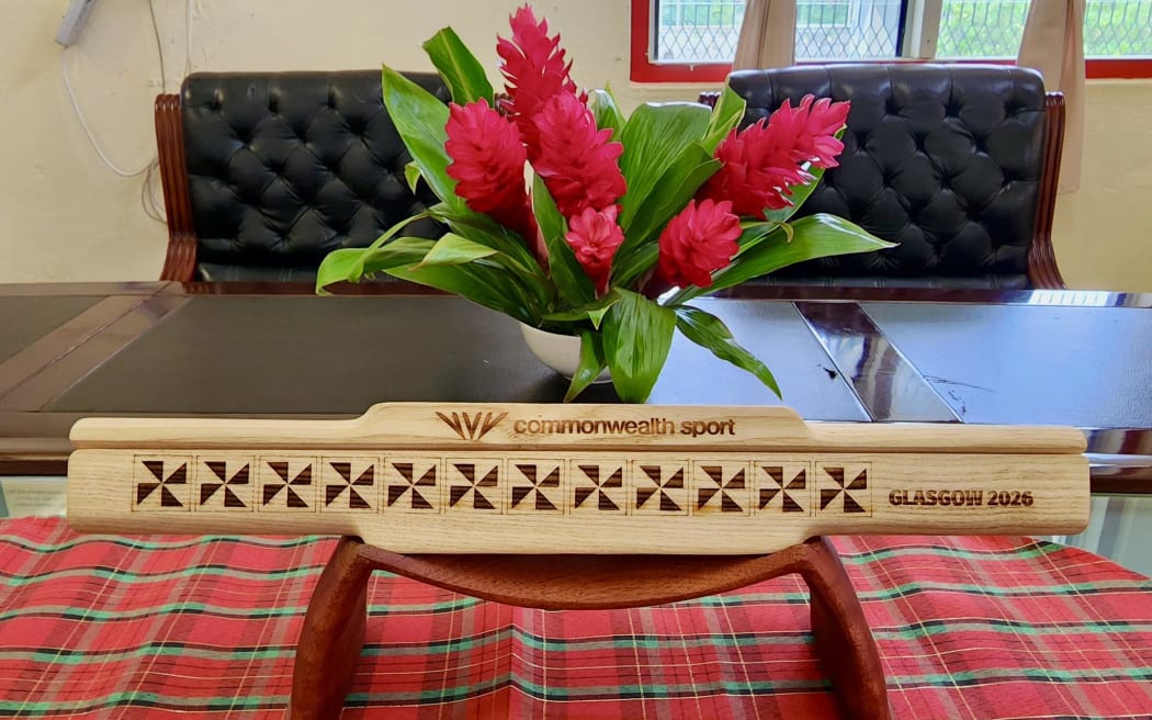 TASANOC Secretary-General and CEO Mrs Netina Latu Vea presents the Tonga baton to British High Commissioner His Excellency Mr. Philip Malone.