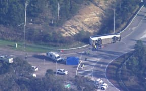 This frame grab taken from video footage provided by Australian Broadcast Corporation (ABC) on June 12, 2023 via AFPTV shows the site of a bus crash, where 10 people from a wedding party were killed, in Cessnock, in Australia's Hunter wine region north of Sydney. A wedding party bus crash killed 10 people in Australia's Hunter wine region north of Sydney, police said on June 12, announcing the arrest of the 58-year-old driver. (Photo by various sources / AFP) / Australia OUT / RESTRICTED TO EDITORIAL USE - MANDATORY CREDIT "AFP PHOTO / ABC" - NO MARKETING - NO ADVERTISING CAMPAIGNS - DISTRIBUTED AS A SERVICE TO CLIENTS