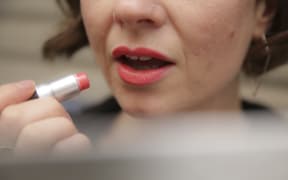 Applying lipstick