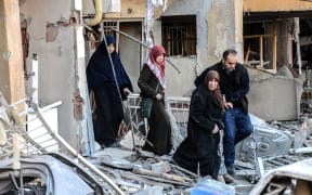 A man and women leave a damaged building at the site of an explosion on 4 November 2016 after a strong blast in Diyarbakir.