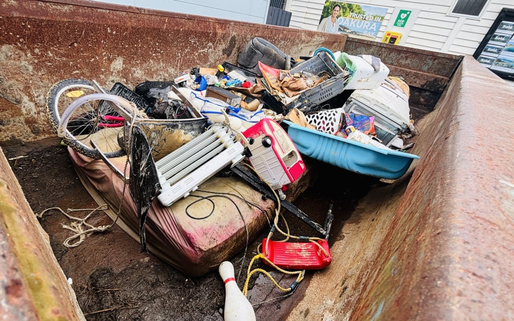 Skip bins at Ōakura have been put out and are filling up with the damaged possessions.