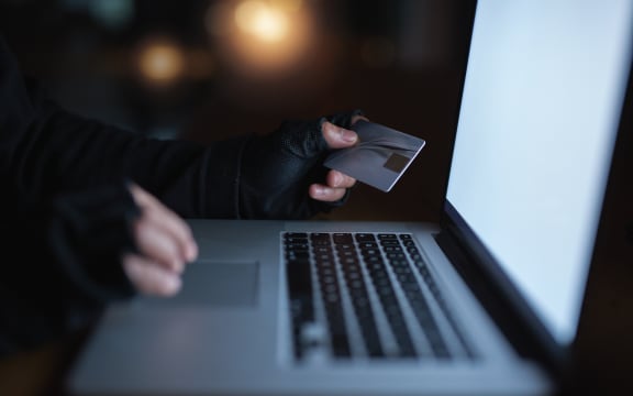 Secure yourself from becoming the next victim of fraud. an unrecognisable hacker using a laptop to hack into a credit account