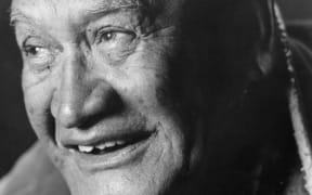 Wiremu (Bill) Kerekere is a smiling man with a gap between his front teeth and cropped white hair.
