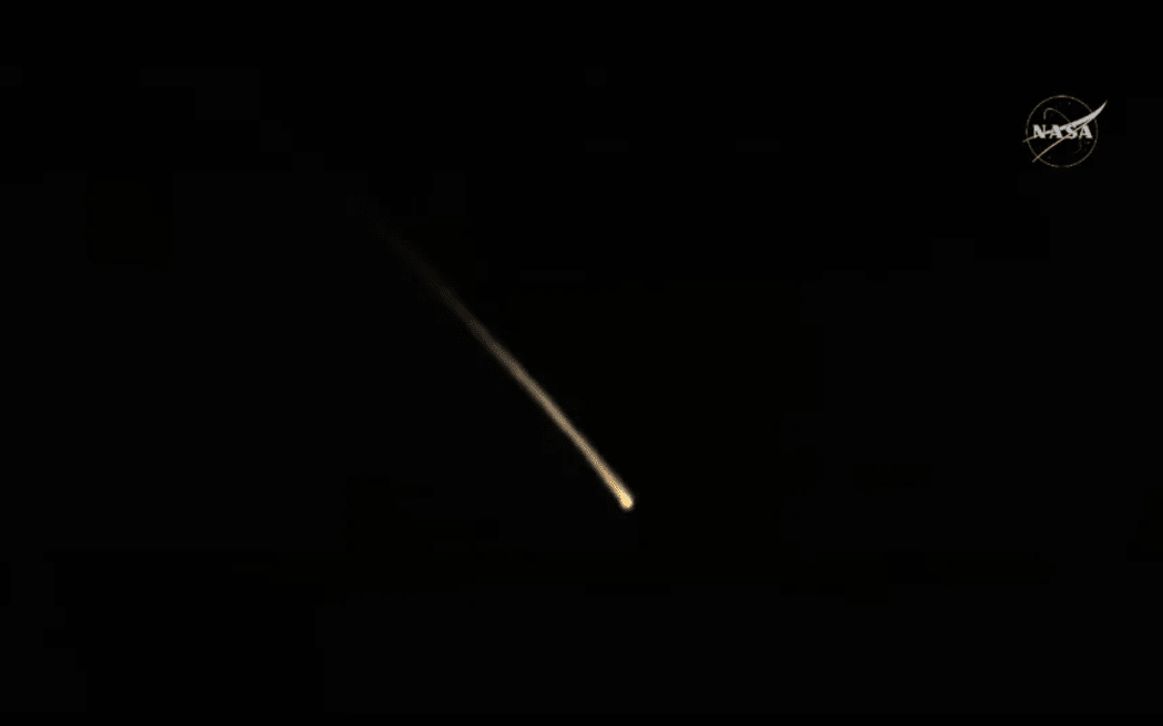 SpaceX Dragon capsule descends toward splashdown.