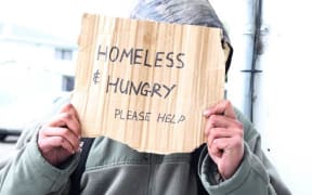 A person begging on a Christchurch street.