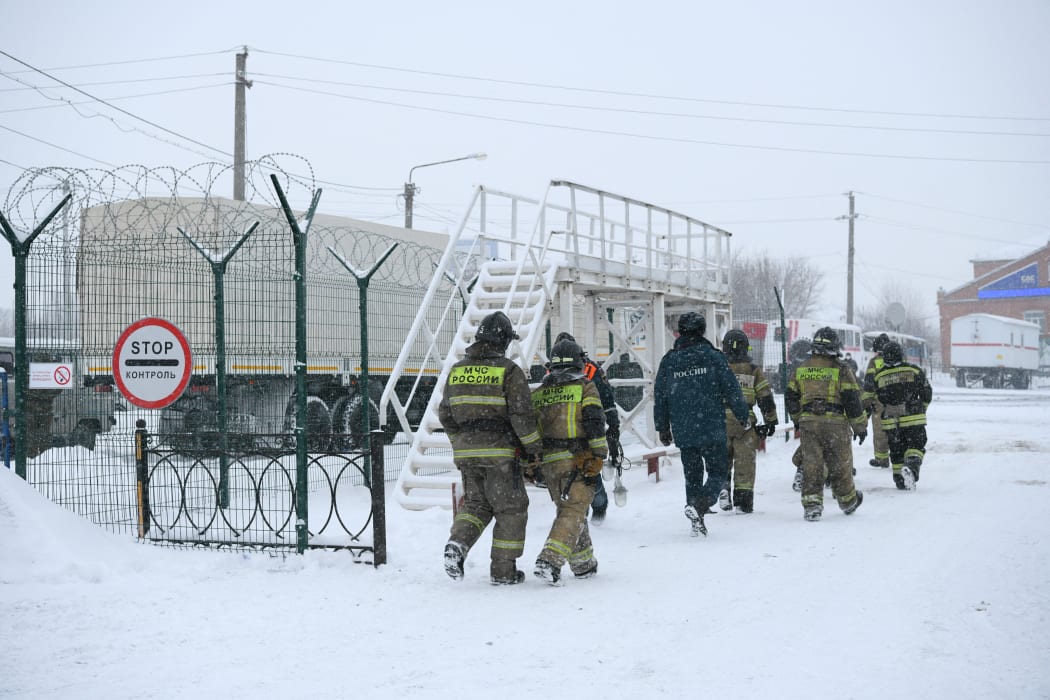 Employees of the Russian Emergency Situations Ministry are seen near the fire site at the Listvyazhnaya coal mine.