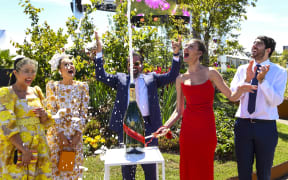Model Montana Cox sprays chamapagne at the Flemington racecourse in Melbourne on November 1, 2021 ahead of the Melbourne Cup.