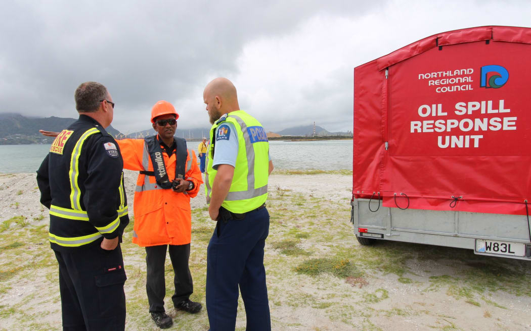 Regional council maritime staff and emergency services representatives at the oil spill today.
