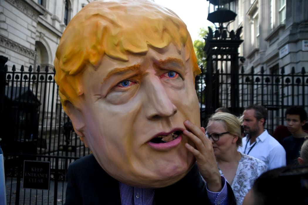 A man wearing a mask of Boris Johnson protests outside Downing Street, after news Parliament will be suspended just days after MPs return to work in September  - and just a few weeks before Brexit.