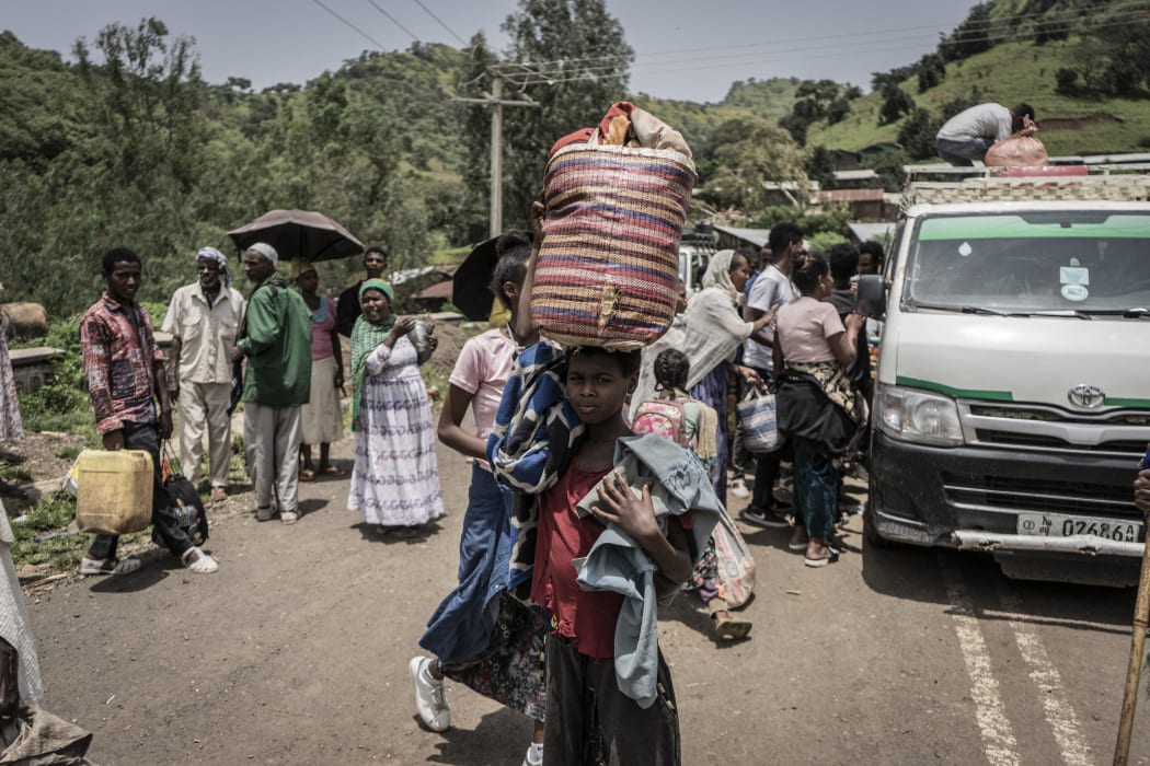 A girl carries her belongings in a basket as she flees flighting between the Ethiopian National Defence Force and Tigray People's Liberation Front, Zarima, 140km from Gondar, Ethiopia, on 16 September 2021.