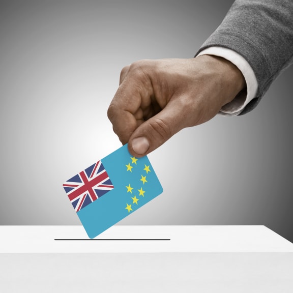 Male holding Tuvalu flag. Voting concept