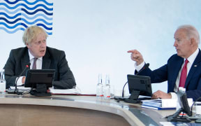 Britain's Prime Minister Boris Johnson (L) listen to US President Joe Biden at a working sesssion during the G7 summit in Carbis Bay, Cornwall on June 12, 2021.