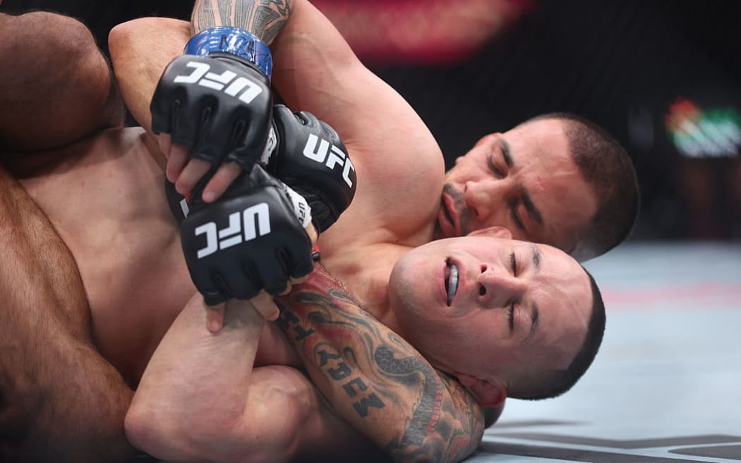 Alexandre Pantoja of Brazil submits Kai Kara-France of New Zealand in their flyweight co-main event title bout during UFC 317.
