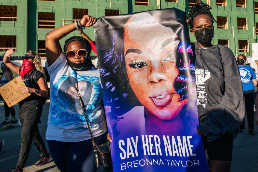 Two women hold a sign of Breonna Taylor during a rally on 18 September 2020 in Louisville, Kentucky.