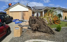 A tornado destroyed the roof and uprooted a large palm tree at this property on Attymon Lane, East Tāmaki, Auckland.