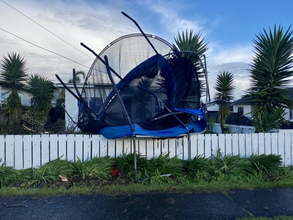 The tornado threw this trampoline on to a fence