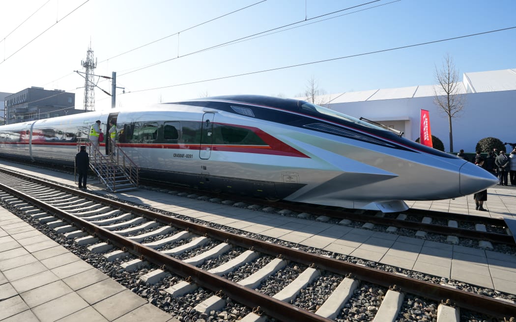 A prototype of the CR450 bullet train that will run at 400 kilometers per hour debuted in Beijing on Dec. 29, said the country's railway operator China State Railway Group Co., Ltd.
  The train is capable of running at 450 kilometers per hour in test. (Xinhua/Ju Huanzong) (Photo by Ju Huanzong / XINHUA / Xinhua via AFP)