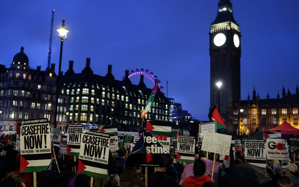 Pro-Palestinian demonstrators wave Palestinian flags and hold placards as they protest in Parliament Square in London during an Opposition Day motion in the the House of Commons calling for an immediate ceasefire in Gaza.